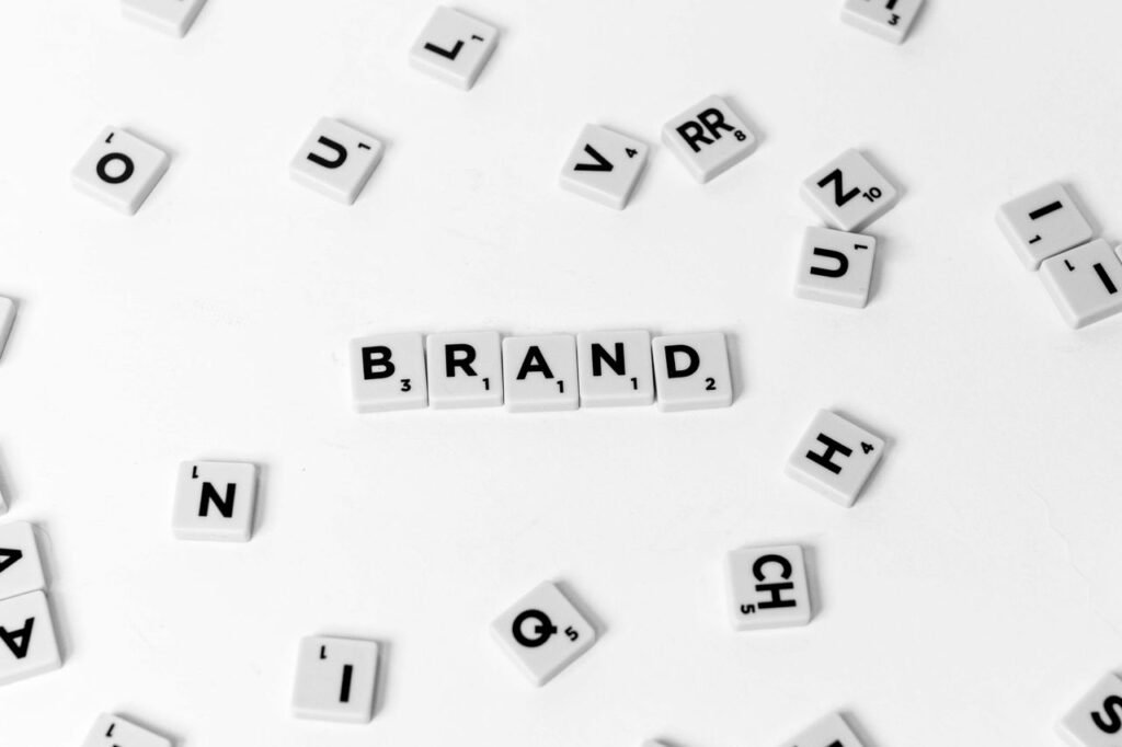 Letter tiles spelling BRAND on a white surface