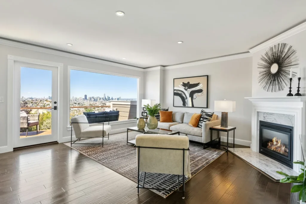 Bright living room with a fireplace and large windows, shot for a real estate listing